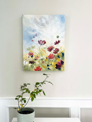 a floral art painting of pink, red, white and burgundy flowers next to a light blue sky