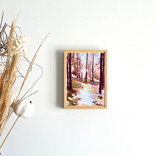 abstract landscape painting of forest in frame and hanging on a wall